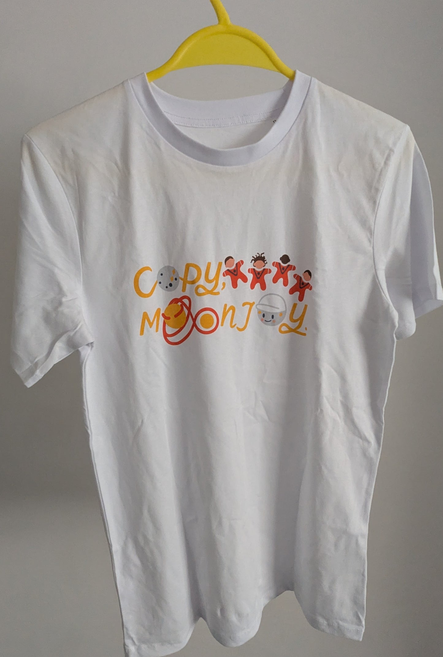 White t-shirt with colourful graphics and text saying 'copy, moon joy' . This is an kids t-shirt sized 12-13 years.